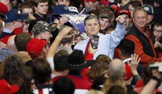Television personality Sean Hannity points as he meets with members of the audience before the start of a campaign rally Monday, Nov. 5, 2018, in Cape Girardeau, Mo., with President Donald Trump. (AP Photo/Jeff Roberson)