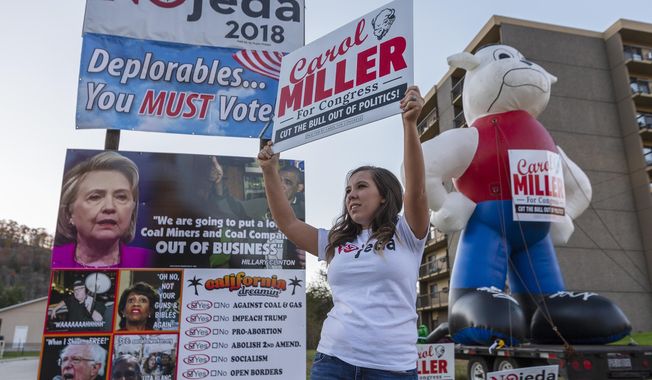 Sierra Belchar waves a sign supporting Carol Miller in Chapmanville, W.Va., on Election Day, Tuesday, Nov. 6, 2018. (Craig Hudson/Charleston Gazette-Mail via AP)