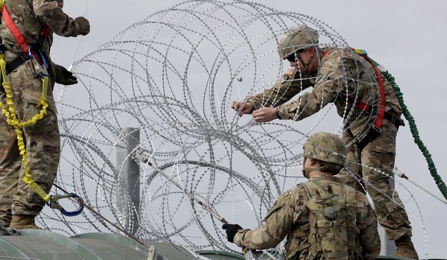 Military members have placed razor wire along the U.S.-Mexico border, but the Pentagon says it has legal authority to build border fencing if it is deemed part of a counterdrug operation or part of a national emergency. (Associated Press/File)