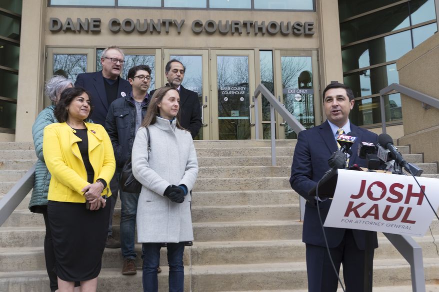 Democratic candidate for state attorney general Josh Kaul, right, claims victory during a news conference Wednesday, Nov. 7, 2018 at the Dane County Courthouse in Madison, Wis. (Mark Hoffman/Milwaukee Journal-Sentinel via AP)