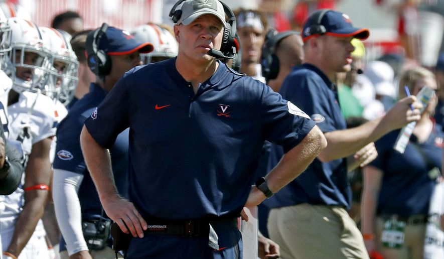 FILE - In this Sept. 29, 2018, file photo, Virginia head coach Bronco Mendenhall watches the action during the second half of an NCAA college football game in Raleigh, N.C. If first-place Pitt or second-place Virginia goes on to win the Coastal title this season, either would become the sixth different school in the last six seasons to win that side of the conference (AP Photo/Chris Seward, File)