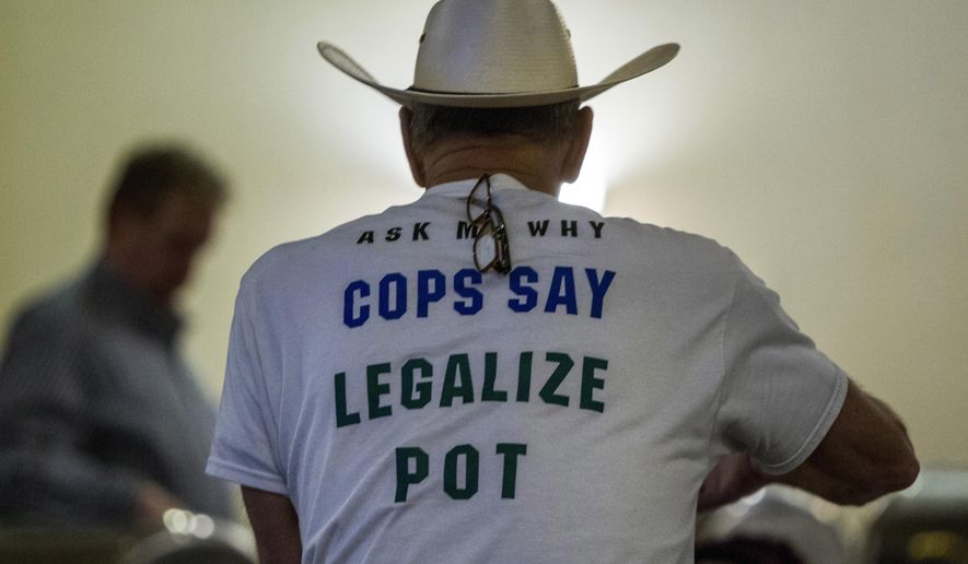 Retired Bath Township Police Det. Howard "Cowboy" Wooldrige waits for election results to come in for Proposal 18-1 during the Coalition to Regulate Marijuana Like Alcohol public watch party at The Radisson in Lansing, Mich., on Tuesday, Nov. 6, 2018. (Cory Morse/The Grand Rapids Press via AP)