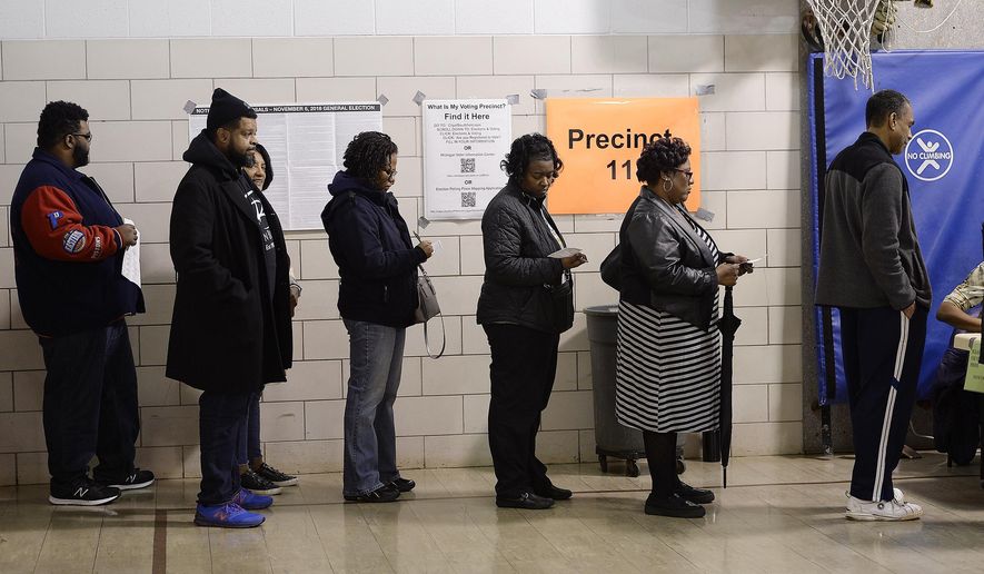 Voters wait in line to vote on Election Day, Tuesday, Nov. 6, 2018, in Southfield, Mich. (Clarence Tabb, Jr /Detroit News via AP) **FILE**