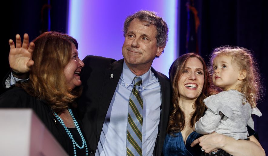 Sen. Sherrod Brown, D-Ohio, hugs his family after speaking to the crowd after winning his reelection bid during the Ohio Democratic Party election night watch party, Tuesday, Nov. 6, 2018, in Columbus, Ohio. (AP Photo/John Minchillo)