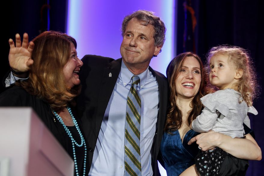 Sen. Sherrod Brown, D-Ohio, hugs his family after speaking to the crowd after winning his reelection bid during the Ohio Democratic Party election night watch party, Tuesday, Nov. 6, 2018, in Columbus, Ohio. (AP Photo/John Minchillo)
