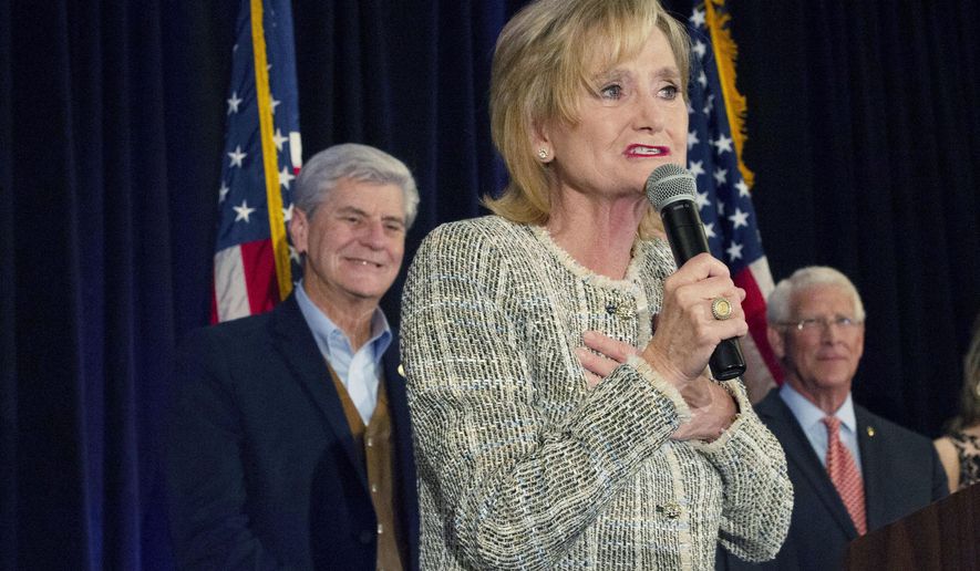 Sen. Cindy Hyde-Smith, R-Miss., speaks to supporters of her campaign during an election night party she shared with fellow Republican U.S. Sen. Roger Wicker, right, in Jackson, Miss., Tuesday, Nov. 6, 2018. Hyde-Smith, who was appointed to the seat, is in a Nov. 27 runoff against Mike Espy in this non-partisan race. The winner will serve the last two years of the six-year term vacated when Republican Thad Cochran retired for health reasons. (Sarah Warnock/The Clarion-Ledger via AP)