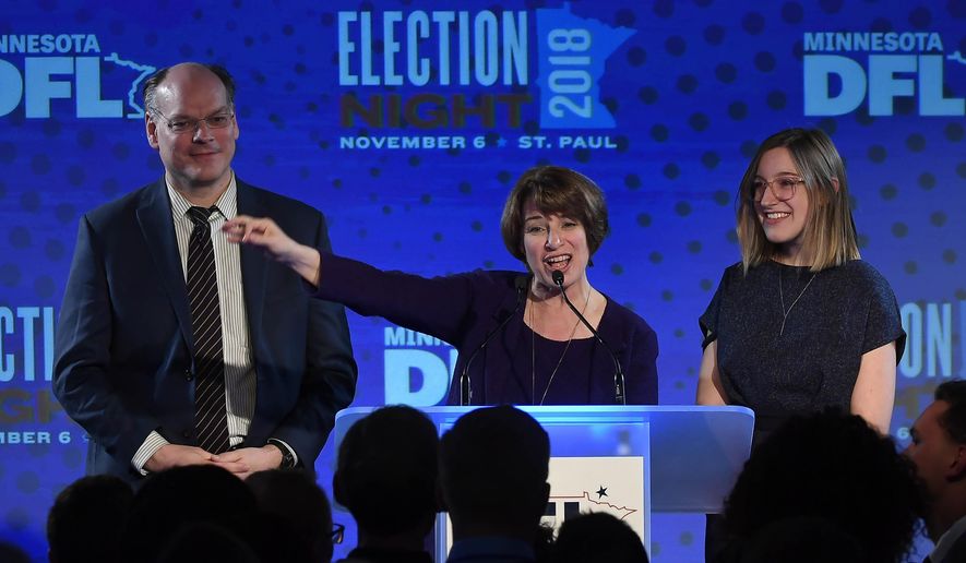 Democratic U.S. Sen. Amy Klobuchar stands beside her husband, John Bessler, and her daughter, Abigail, during her victory speech at the DFL headquarters election party at the Intercontinental Hotel Tuesday, Nov. 6, 2018, in St. Paul, Minn. Klobuchar defeated Republican state Rep. Jim Newberger. (Aaron Lavinsky/Star Tribune via AP) ** FILE **
