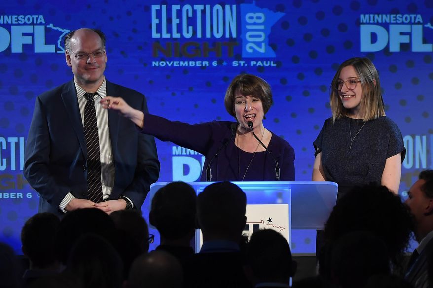 Democratic U.S. Sen. Amy Klobuchar stands beside her husband, John Bessler, and her daughter, Abigail, during her victory speech at the DFL headquarters election party at the Intercontinental Hotel Tuesday, Nov. 6, 2018, in St. Paul, Minn. Klobuchar defeated Republican state Rep. Jim Newberger. (Aaron Lavinsky/Star Tribune via AP) ** FILE **