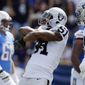 FILE- In this Oct. 7, 2018, file photo, Oakland Raiders defensive end Bruce Irvin, center, reacts after sacking Los Angeles Chargers quarterback Philip Rivers during the first half of an NFL football game in Carson, Calif.  The Atlanta Falcons have signed Irvin to a one-year deal announced Wednesday, Nov. 7, 2018, reuniting the veteran with coach Dan Quinn. Irvin, cut by the Oakland Raiders on Saturday, became a free agent after clearing waivers on Tuesday with $3.8 million remaining on his contract. (AP Photo/Mark J. Terrill, File)