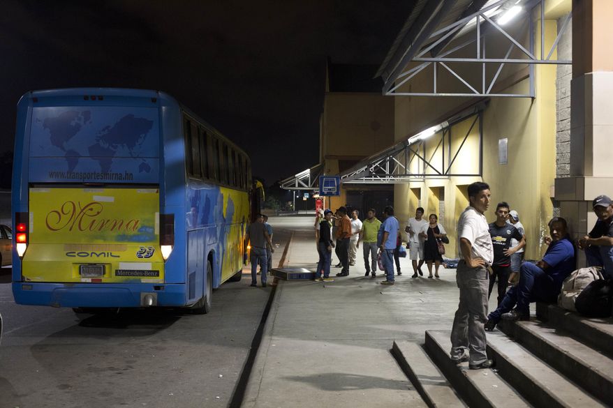 In this Oct. 30, 2018 photo, Honduran migrants deported from Mexico wait to be transported home, at the Metropolitan Grand Central bus terminal in San Pedro Sula, Honduras, after failing to complete their journey to the U.S. border. Nearly all the migrants at the terminal said the same thing: Maybe not today, maybe not tomorrow, but they intend to try again. (AP Photo/Moises Castillo)