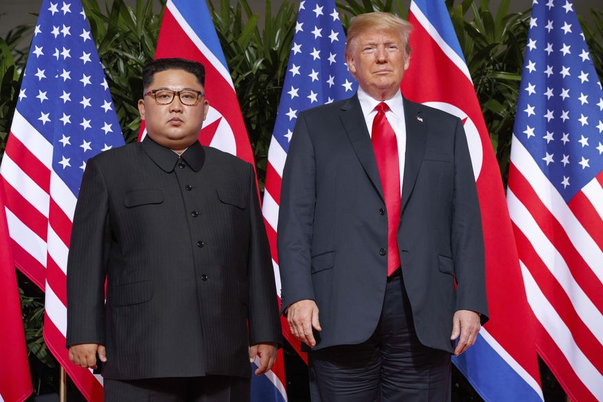 In this June 12, 2018, file photo, U.S. President Donald Trump, right, stands with North Korean leader Kim Jong Un on Sentosa Island in Singapore. North Korea and the United States are trying to revive stalled diplomacy meant to rid the North of its nuclear weapons. There was much talk of the possibility of success following a meeting in June between Trump and Kim, but in the months since there has been little to quiet skeptics who believe the North will never give up weapons it has described as necessary to counter a hostile Washington. (AP Photo/Evan Vucci) **FILE**