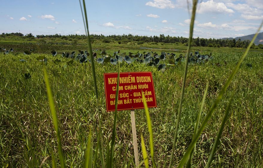 FILE - In this Aug. 9, 2012, file photo, a warning sign stands in a field contaminated with dioxin near Danang airport, during a ceremony marking the start of a project to clean up dioxin left over from the Vietnam War, at a former U.S. military base in Danang, Vietnam. The sign reads; &amp;quot;Dioxin contamination zone - livestock, poultry and fishery operations not permitted.&amp;quot; Vietnam and the United States have finished cleaning up dioxin contamination at the airport caused by the transport and storage of the herbicide on and around the area. (AP Photo/Maika Elan, File)