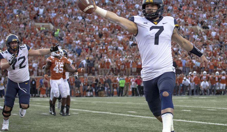 FILE - In this Saturday, Nov. 3, 2018, file photo, West Virginia quarterback Will Grier (7) scores the game-winning, two-point conversion during an NCAA college football game against Texas in Austin, Texas. Grier has thrown for 699 yards and six touchdowns without an interception in his last two games. (Nick Wagner/Austin American-Statesman via AP, File)