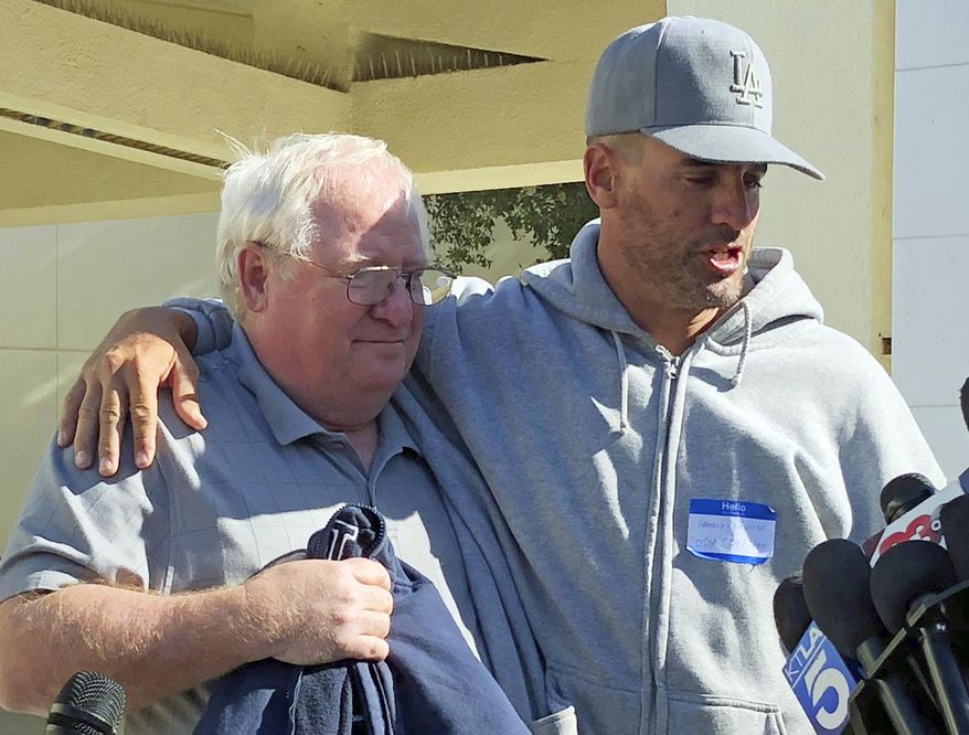 Jason Coffman, right, talks to the media about his son, Cody Coffman, who died in the shooting, and holds onto his father-in-law, Mike Johnston, in Thousand Oaks, Calif., Thursday, Nov. 8, 2018. (AP Photo/Jonathan J. Cooper)