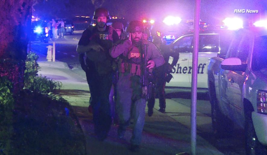 In this image taken from video police officers and FBI agents run at the scene of a shooting, early Thursday morning, Nov. 8, 2018, in Thousand Oaks, Calif.  A hooded gunman dressed entirely in black opened fire on a crowd at a country dance bar holding a weekly &amp;quot;college night&amp;quot; in Southern California, killing multiple people and sending hundreds fleeing including some who used barstools to break windows and escape, authorities said Thursday. The gunman was later found dead at the scene.  (RMG News via AP)