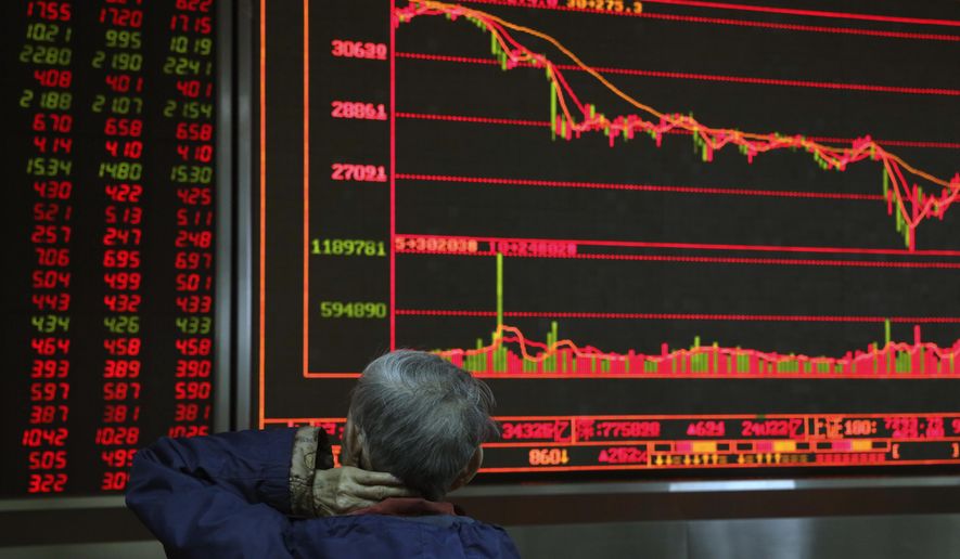 A Chinese man monitors stock prices at a brokerage in Beijing, China, Thursday, Nov. 8, 2018. Asian markets rose on Thursday after the U.S. midterm elections went as expected, soothing fears of a sudden shift on trade and economic policies. (AP Photo/Ng Han Guan)
