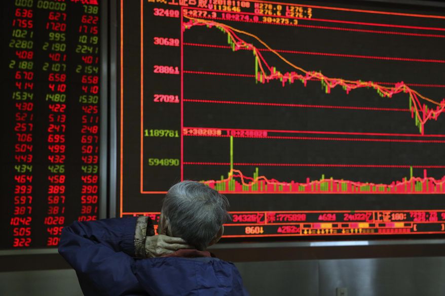 A Chinese man monitors stock prices at a brokerage in Beijing, China, Thursday, Nov. 8, 2018. Asian markets rose on Thursday after the U.S. midterm elections went as expected, soothing fears of a sudden shift on trade and economic policies. (AP Photo/Ng Han Guan)