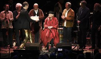 Joni Mitchell is presented with a birthday cake on stage at JONI 75: A Birthday Celebration on Wednesday, Nov. 7, 2018, at the Dorothy Chandler Pavilion in Los Angeles. (Photo by Richard Shotwell/Invision/AP)