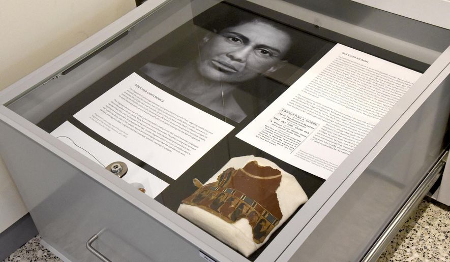 In a Sept. 26, 2018 photo, a pull-out drawers offer more information about the facial depiction process at the new Johns Hopkins Archaeological Museum exhibit, &amp;quot;Who Am I? Remembering the Dead Through Facial Reconstruction,&amp;quot; in Baltimore. Pictured here is the facial depiction of the Goucher mummy, and her &amp;quot;boot.&amp;quot; FaceLab, Liverpool John Moores University, worked with Hopkins to create facial depictions of the Goucher mummy, ca. 4th c. BCE, and the Cohen mummy, ca. 664 - 525 BCE. (Amy Davis/The Baltimore Sun via AP)
