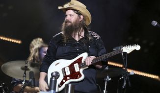 FILE - In this June 9, 2018 file photo, Chris Stapleton performs at the 2018 CMA Music Festival in Nashville, Tenn. Stapleton&#39;s “Broken Halos” is nominated for single of the year and song of the year for the Country Music Association Awards. (Photo by Laura Roberts/Invision/AP, File)