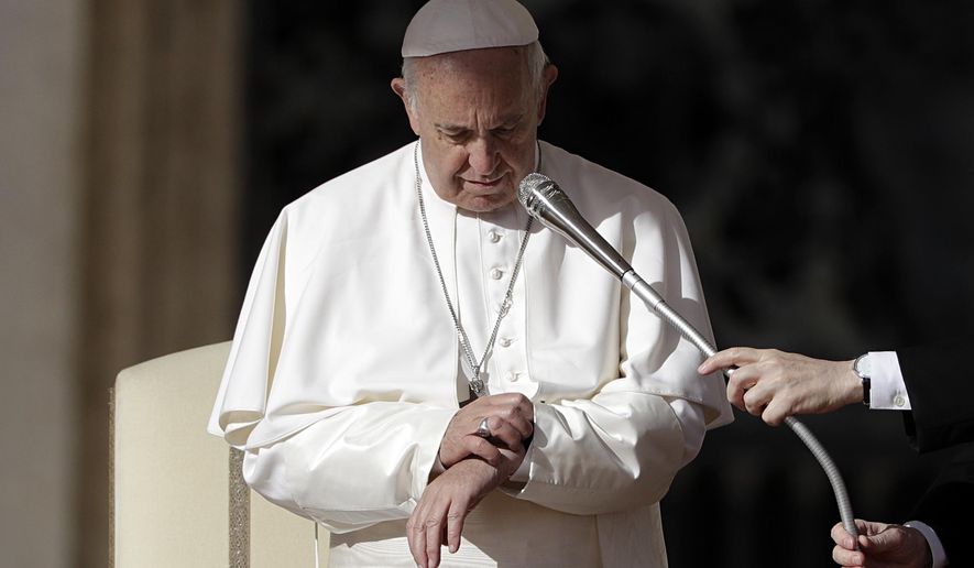 Pope Francis checks his watch as he arrives for the weekly general audience in St.Peter's Square at the Vatican, Wednesday, Nov. 7, 2018. (AP Photo/Gregorio Borgia)