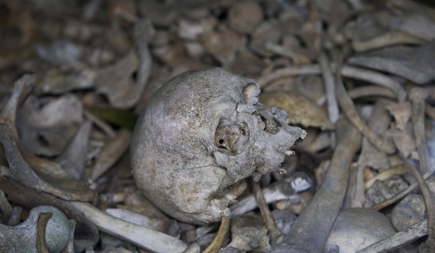 In this file photo taken on April 3, 2017, the bones of soldiers are piled in a crypt at the Douaumont Ossuary in Verdun, France. Hundreds of troops died on the final morning of World War I — even after an armistice was reached and before it came into force. Death at literally the 11th hour highlighted the futility of a conflict that had become even more incomprehensible in four years of battle. (AP Photo/Virginia Mayo, File)