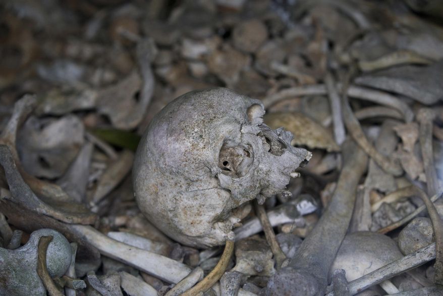 In this file photo taken on April 3, 2017, the bones of soldiers are piled in a crypt at the Douaumont Ossuary in Verdun, France. Hundreds of troops died on the final morning of World War I — even after an armistice was reached and before it came into force. Death at literally the 11th hour highlighted the futility of a conflict that had become even more incomprehensible in four years of battle. (AP Photo/Virginia Mayo, File)