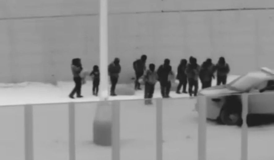 This image from video provided by the Yuma Sector Border Patrol shows a group of migrants who crawled through a hole that had been dug under the U.S.-Mexico border wall at the San Luis port of entry near Yuma, Arizona on Nov. 7. (Associated Press)