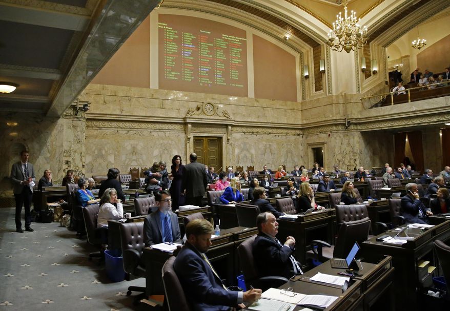 In this June 30, 2017 file photo, voting results are projected above the House floor of the Washington Legislature at the Capitol in Olympia, Wash. (AP Photo/Ted S. Warren, File) **FILE**