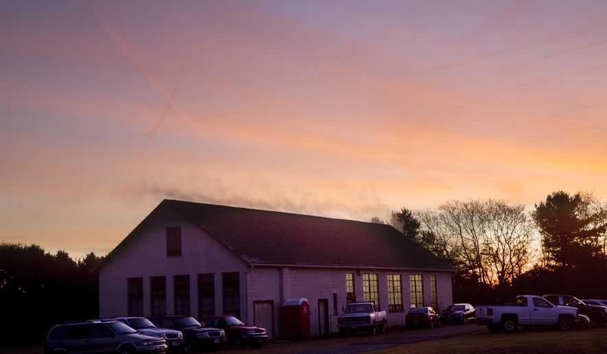 This photo taken Oct. 25, 2018, shows the sun rising over the Glade Hill Cannery in Franklin County, Va. (Stephanie Klein Davis /The Roanoke Times via AP)