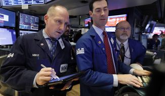Trader Michael Urkonis. left, works with specialists John McNierney, center, and Douglas Johnson on the floor of the New York Stock Exchange, Friday, Nov. 9, 2018. Stocks are falling as energy companies are dragged lower by the continuing plunge in crude oil prices. (AP Photo/Richard Drew)