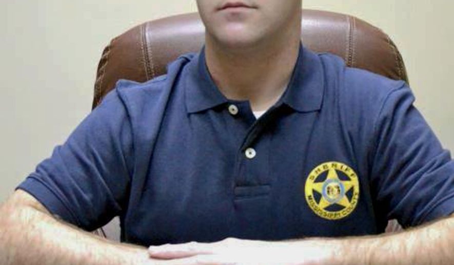 FILE - In this undated file photo, Mississippi County Sheriff Cory Hutcheson sits behind his desk at the Mississippi County Detention Center in Charleston, Mo. The family of a mentally ill Tennessee man who died after being subdued at the Mississippi County, Missouri, jail in May 2017 is seeking $20 million in a federal lawsuit. Tory Sanders died at a hospital after a scuffle with then-Sheriff Hutcheson and other officers. The lawsuit alleges that Hutcheson ignored warnings from another officer to stop putting pressure on Sanders&#39; neck, responding, &amp;quot;No, I&#39;m good.&amp;quot; (Leonna Heuring/Sikeston Standard Democrat via AP, File)
