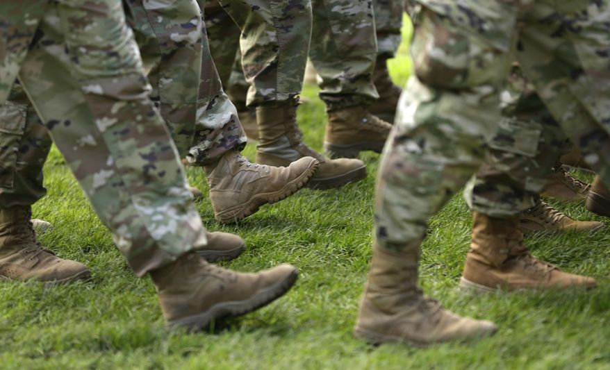 FILE- In this April 3, 2017, file photo U.S. Army soldiers march in formation during a change of command ceremony at Joint Base Lewis-McChord in Washington. If you’re a veteran with student debt, you have repayment rights unique to military service members that can keep you on track and out of default. (AP Photo/Ted S. Warren, File)