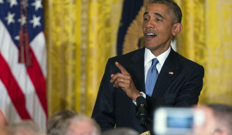 FILE - In this Wednesday, June 24, 2015 file photo, President Barack Obama responds to a heckler as he speaks during a reception to celebrate LGBT Pride Month in the East Room of the White House in Washington. On Friday, Nov. 9, 2018, The Associated Press has found that stories circulating on the internet that Obama threw a reporter out of the news conference for asking a question are untrue. (AP Photo/Evan Vucci)
