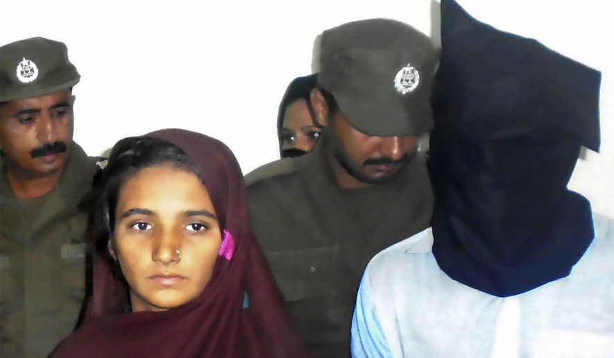 FILE - In this Monday, Oct. 30, 2017 file photo, Aasia Bibi and her boyfriend, Shahid Lashari, are presented to journalists, at police station in Muzaffargarh in Pakistan. A Pakistani court has found a woman and his friend guilty of poisoning to death 17 members of a family and sentenced them multiple life terms in prison. Police officer Zafar Iqbal says Friday, Nov. 9, 2018 that anti-terrorism court's judge Shakir Hasan also fined Bibi and Lashari three million rupees ($23000) each. The court ordered Thursday that 15 life terms will run simultaneously. (AP Photo/Irum Asim)