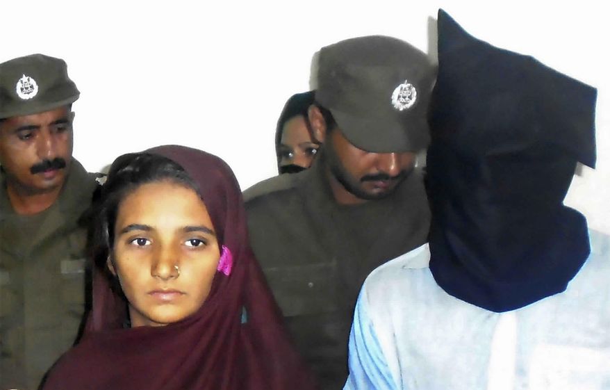FILE - In this Monday, Oct. 30, 2017 file photo, Aasia Bibi and her boyfriend, Shahid Lashari, are presented to journalists, at police station in Muzaffargarh in Pakistan. A Pakistani court has found a woman and his friend guilty of poisoning to death 17 members of a family and sentenced them multiple life terms in prison. Police officer Zafar Iqbal says Friday, Nov. 9, 2018 that anti-terrorism court's judge Shakir Hasan also fined Bibi and Lashari three million rupees ($23000) each. The court ordered Thursday that 15 life terms will run simultaneously. (AP Photo/Irum Asim)