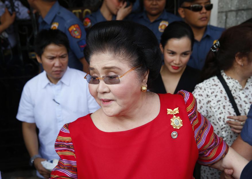 FILE - In this Oct. 16, 2018, file photo, former Philippines first lady and widow of the late dictator Ferdinand Marcos, Congresswoman Imelda Marcos arrives at the Commission on Elections to lend her support for her daughter Governor Imee Marcos in filing her Certificate of Candidacy or COC for a Senate seat in the May 2019 midterm elections in Manila, Philippines. A Philippine court found former first lady Imelda Marcos guilty of graft and ordered her arrest Friday, Nov. 9, 2018, in a rare conviction among many corruption cases that she&#39;s likely to appeal to avoid jail and losing her seat in Congress. (AP Photo/Bullit Marquez, File)