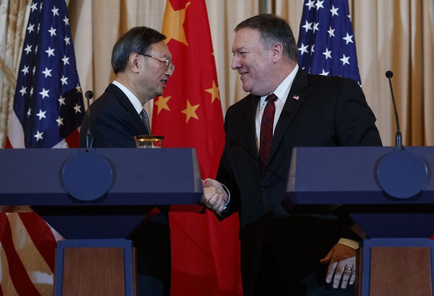 Secretary of State Mike Pompeo, right, shakes hands with Chinese Politburo Member Yang Jiechi at the conclusion of a news conference at the State Department in Washington, Friday, Nov. 9, 2018. (AP Photo/Carolyn Kaster)