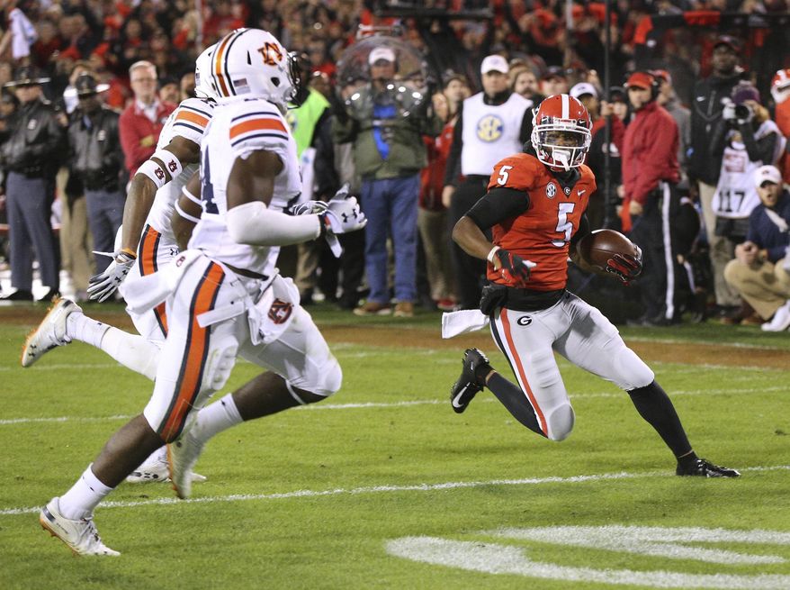 Georgia wide receiver Terry Godwin gets past Auburn defenders for a 37-yard touchdown catch against Auburn during the second quarter of an NCAA college football game on Saturday, Nov. 10, 2018, in Athens, Ga. (Curtis Compton/Atlanta Journal-Constitution via AP)