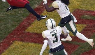 Iowa State wide receiver Deshaunte Jones (8) leaps to catch a touchdown pass over Baylor safeties Verkedric Vaughns, right, and Chris Miller, bottom, during the first half of an NCAA college football game, Saturday, Nov. 10, 2018, in Ames. (AP Photo/Matthew Putney)