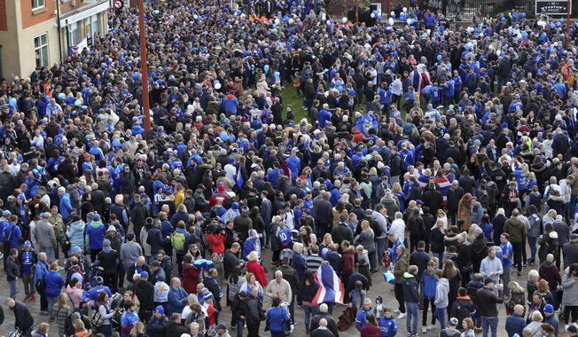 Leicester City fans gather at Jubilee Square in Leicester, before taking part in a memorial walk to the King Power Stadium, in honour of the club&#x27;s owner Vichai Srivaddhanaprabha and four others who died in a helicopter crash outside the stadium on October 27.  Saturday Nov. 10, 2018. (Aaron Chown/PA via AP)