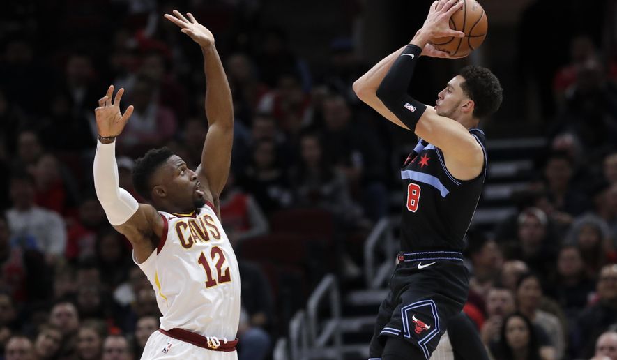 Chicago Bulls guard Zach LaVine, right, shoots against Cleveland Cavaliers guard David Nwaba during the first half of an NBA basketball game Saturday, Nov. 10, 2018, in Chicago. The Bulls won 99-98. (AP Photo/Nam Y. Huh)