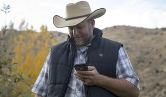 In this undated photo, Ammon Bundy receives a call from a former fellow inmate while picking Gypsy Lust apples in his orchard in Emmett, Idaho. Bundy calls himself a &amp;quot;sunlight kind of guy.&amp;quot; Before his family&#39;s infamous standoffs near Bunkerville, Nevada, and Burns, Oregon, he was living in the dark, he told the Idaho Statesman. Now he&#39;s got a new view on life that he&#39;s eager to share, he said, and some Idahoans are eager to listen. (Kelsey Grey/Idaho Statesman via AP)