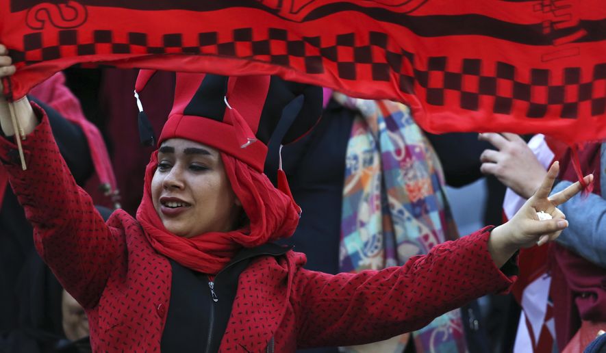 A female Iranian spectator waves a flag of her favorite team Persepolis prior to start their soccer match with Japan&#39;s Kashima Antlers during the 2nd leg of the Asian Champions League finals at the Azadi (freedom) stadium in Tehran, Iran, Saturday, Nov. 10, 2018. Authorities allowed a select group of women into Azadi stadium to watch men&#39;s soccer match, a rare move in the Islamic theocracy. Since the 1979 Islamic Revolution women have not been allowed to watch men&#39;s soccer matches in stadiums, though they have occasionally been allowed to watch volleyball and basketball in stadiums. (AP Photo/Vahid Salemi)
