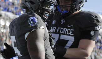Air Force quarterback Donald Hammond III (5) celebrates a touchdown run with teammate Taven Birdow (33) during the first half of an NCAA college football game against New Mexico, Saturday, Nov. 10, 2018, at Air Force Academy, Colo. (AP Photo/Jack Dempsey)