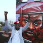 FILE - In this Friday Oct. 12, 2018 file photo, Kyadondo MP Robert Kyagulanyi, alias Bobi Wine, gestures during a visit to Nairobi, Kenya. Ugandan pop star and opposition politician Bobi Wine staged his first concert since being charged with treason, in a show of defiance punctuated by anti-government slogans and barbs aimed at the long-time president he is challenging. Thousands of Ugandans attended the lakeside event Saturday, Nov. 10 outside the capital, Kampala, many of them clad in red outfits symbolizing their allegiance to the “People Power” movement led by Wine. (AP Photo/Brian Inganga, file)