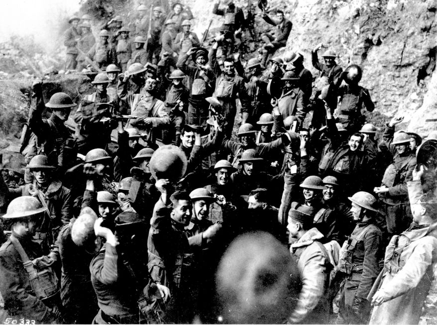 FILE In this Nov. 11, 1918 file photo, American troops cheer after hearing the news that the Armistice had been signed, ending World War I. At 11 a.m. on the 11th day of the 11th month of 2018, scores of world leaders are gathering in Paris to mark 100 years since the armistice that ended World War I entered into force, and to celebrate peace. (AP Photo, File)