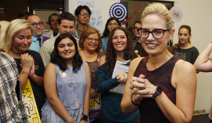 Democratic Rep. Kyrsten Sinema, who is running against Republican Rep. Martha McSally for the open Arizona Senate seat Jeff Flake, R-Ariz., is vacating, talks to campaign volunteers, Tuesday, Oct. 2, 2018, in Tempe, Ariz. Arizona&#39;s Senate race pits Sinema, a careful politician running as a centrist in a Republican-leaning state, against McSally, a onetime Trump critic turned fan. (AP Photo/Ross D. Franklin)