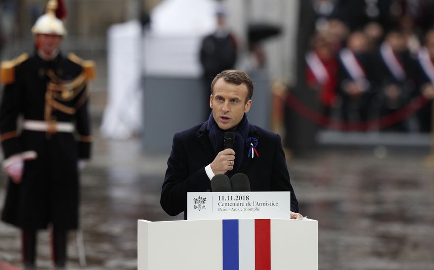 French President Emmanuel Macron delivers his speech during ceremonies at the Arc de Triomphe Sunday, Nov. 11, 2018 in Paris. Over 60 heads of state and government were taking part in a solemn ceremony at the Tomb of the Unknown Soldier, the mute and powerful symbol of sacrifice to the millions who died from 1914-18. (AP Photo/Francois Mori, Pool)
