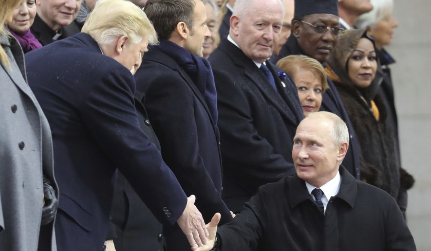 Russian President Vladimir Putin shakes hands with US President Donald Trump as he arrives to attend a ceremony at the Arc de Triomphe in Paris, Sunday, Nov. 11, 2018, as part of commemorations marking the 100th anniversary of the 11 November 1918 armistice, ending World War I. (Ludovic Marin/Pool Photo via AP)